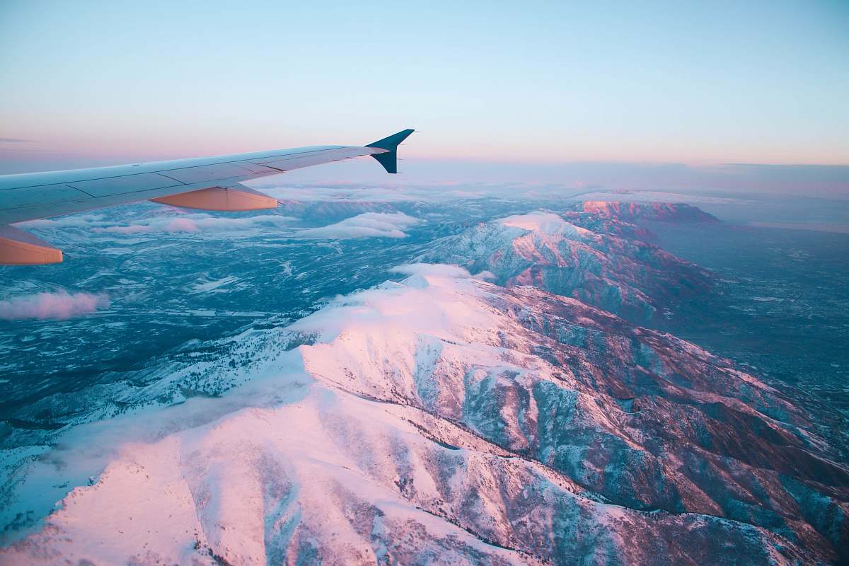 salt lake city plane flying above white mountains during daytime aircraft